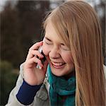 Blond girl laughing and talking on cell phone