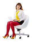 Young woman in bright clothes sitting in a chair with a laptop isolated on white background