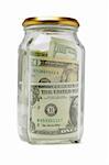 US dollar bills in closed glass container on white background