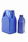 Plastic containers of lubrication oil on white background