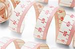 Close up of measuring tapes on white background