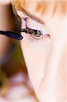 bride is doing make up for wedding celebration