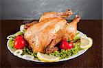 Roast chicken with fresh vegetables, studio shot