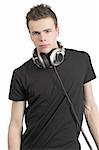 Photo of a male in his late teens, wearing headphones around his neck.