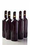 photo of five wine bottles in front of white isolated background