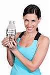 A beautiful woman holding her retirement account of coins in a milk bottle