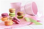 Delicious French Macaroons with ribbons on table