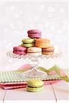 French macaroons on cake tray with vintage background