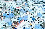 Pieces of puzzle spilled on table, abstract background