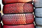 close up of racetrack fence of  red and white old tires