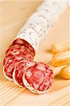 Spanish fuet salami chopped on  wooden board