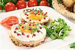 Potato pancakes with ham, egg, red pepper, chives and fresh salad