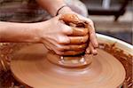 clay potter hands closeup working on wheel handcrafts pottery work