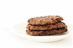 Stack of home made oatmeal cookies with molasses on white plate
