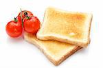 Two pieces of toast on the table with tomatoes