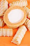 Swedish almond tart and danish macaroon fingers on a orange plate.