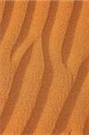 waves textures on desert sand orange background