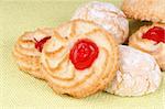 Close-up of assorted sicilian almond pastries decorated with candies cherries, icing sugar and granulated sugar. Selective focus.