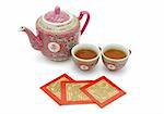 Chinese longevity tea set and red packets for tea ceremony on white background