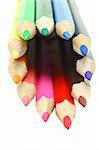 Assortment of colored pencils arranged in circle on white background
