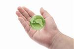 Green crystal globe in young boy's palm on white background