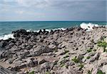 Rocky beach with sea waves splashes