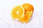 Fresh oranges in ice, close up view