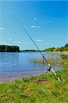 Fishing rod by the lake. Fishing scene.