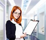 Portrait of the business woman with a represent folder. Studio shot.