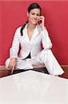 Beautiful business woman holding cell phone and smiling