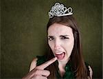 Disgusted Young Woman with a crown tiara and gagging gesture