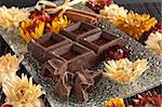 broken piece of chocolate composition with flowers