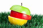 Combination of green, yellow and red apples on grass on a white background