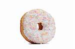 Pink Iced Doughnut covered in sprinkles isolated against white background