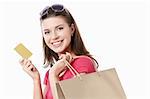 Young girl with a credit card and shopping bags isolated