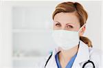 Female scientist with a mask and a stethoscope posing in a lab