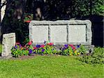 Ancient blank tombstone in a northen graveyard wih grass field