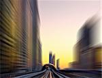 Modern city at sunset, metro overpass with rails, Dubai city in United Arab Emirates