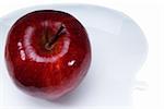 red apple on a white plate