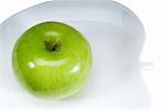 green apple on a white plate