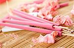 Spa treatment in bright pink and white palette, petals, and arotatizirovannye sticks on a wooden bamboo rug