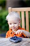 adorable toddler eating blueberries