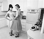 Happy Caucasian housewives in a retro kitchen with hand on hips