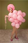 Big beautiful drag queen with pink balloons over green background