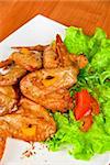 roasted chicken wings garnished with fresh green salad, pepper and greens