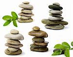 balanced spa stones with green plant isolated on white background