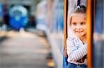 Cheerful little girl peeping from the train