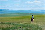 Riding horse in grassland of Hulun Buir League of Inner-Mongolia, China