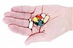 hand with various pills over white background