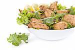 Chicken salad with dropped leaves over white background